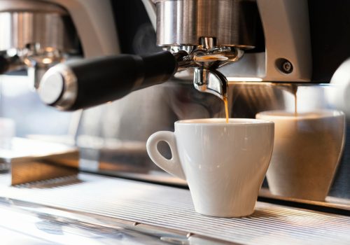 close-up-machine-pouring-coffee-cup